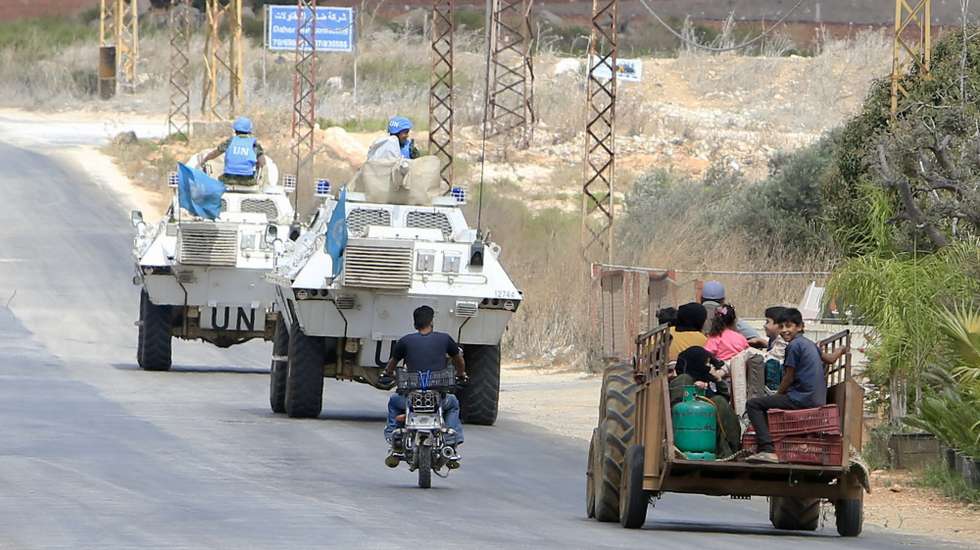 epa11606106 Syrian refugees ride a tractor near United Nations Interim Force (UNIFIL) vehicles as they leave Wazzani village, southern Lebanon, 15 September 2024. Displaced Syrian refugees, who used to work in agricultural fields in Wazzani village, are leaving the area after leaflets reportedly dropped by the Israel Defense Forces (IDF) demanded the evacuation of civilians from the Wazzani area and surroundings by 4pm local time due to Hezbollah activity in the area. The IDF did not immediately issue an official comment about the evacuation recommendation.  EPA/STR