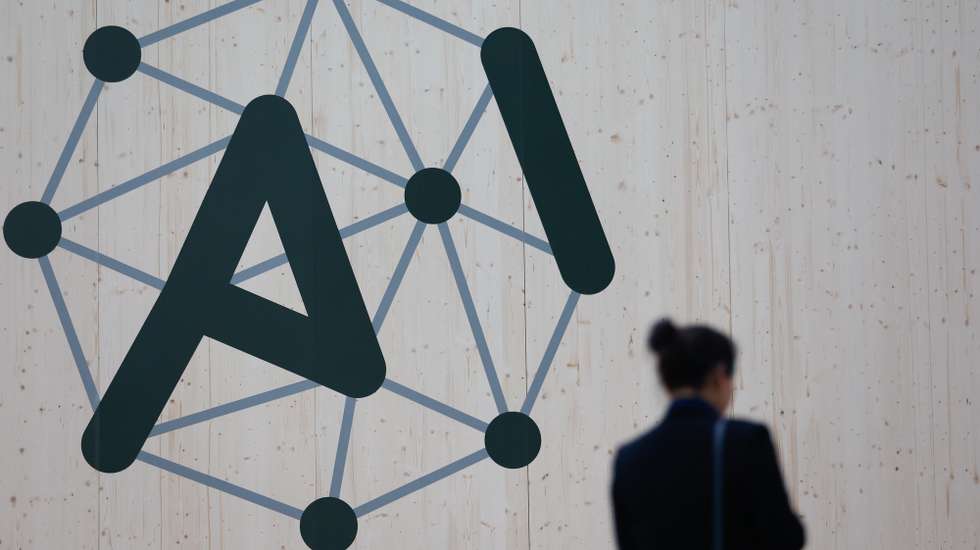 epa11886490 A person walks past the logo of the Artificial Intelligence (AI) Action Summit at the Grand Palais in Paris, France, 10 February 2025. The summit takes place from 10 to 11 February.  EPA/MOHAMMED BADRA