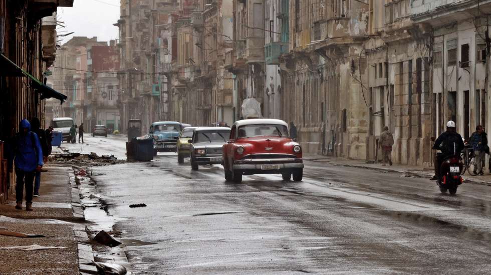 epa12698062 Vehicles drive along a street during a rainfall in Havana, Cuba, 01 February 2026. A cold front and strong swells are expected to cause flooding along the northern coast of western Cuba, likely impacting Havana. Increased northwest winds and heavy swells, which could reach significant intensities, are forecast for the northern coast.  EPA/ERNESTO MASTRASCUSA