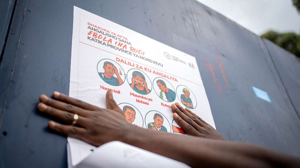 epa12978406 A staff with the non-governmental organization AGIR-RDC that promotes medical access, displays a poster describing preventive measures against Ebola, in Goma, North Kivu, Democratic Republic of Congo, 20 May 2026. The World Health Organization (WHO) has reported over 130 deaths linked to the outbreak of the Bundibugyo variant of Ebola in the Democratic Republic of the Congo, officially declared public health emergency of international concern (PHEIC).  EPA/MARIE JEANNE MUNYERENKANA