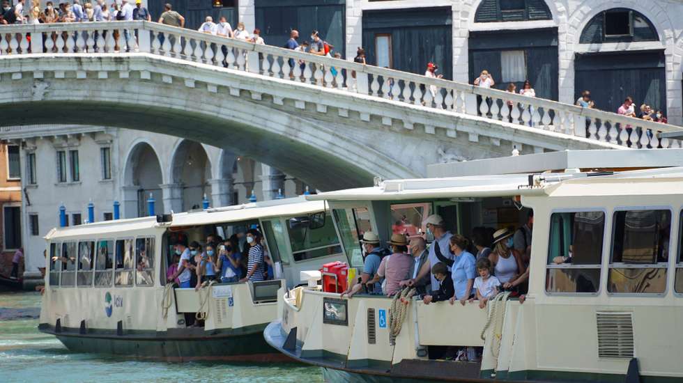 epa09250919 Tourists on the vaporetto 'Venetian public waterbus' on the Canal Grande, in Venice, Italy, 06 June 2021. On 04 June 2021, The Italian Health Ministry announced that the Italian regions of Abruzzo, Liguria, Umbria and Veneto will fall in the low-risk white zone starting 07 June 2021.  EPA/Andrea Merola