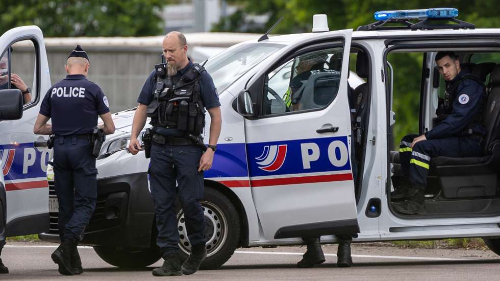 epa11339833 French policemen stand guard at the toll station of Incarville, near Rouen, in the North of France, where gunmen ambushed a prison van on 14 May 2024, killing two prison guards and helping a prisoner to escape. Three other prison guards were severely wounded, according to Justice minister Eric Dupond-Moretti. A major police manhunt has been launched to find the gunmen and the escaped prisoner,  identified as a 30-year-old drug dealer from northern France, according to the Paris prosecutor's office.  EPA/CHRISTOPHE PETIT TESSON