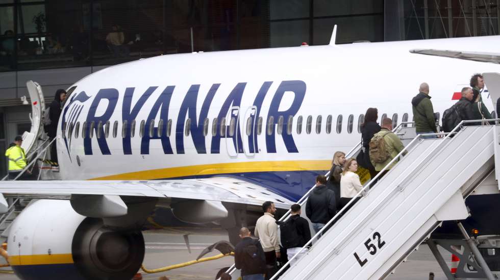 epa11310199 Passengers board a Ryanair group airplane at Riga Airport, Latvia, 30 April 2024. Riga Airport is the international airport of Riga, the capital of Latvia, and the largest airport in the Baltic states.  EPA/TOMS KALNINS