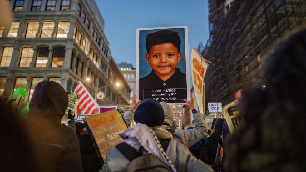 epa12676242 People march with a photograph of a five year old boy detained in Minneapolis by federal immigration enforcement agents, during a protest in New York, New York, USA, 23 January 2026. Nationwide protests continue after a federal immigration operation in which an ICE officer fatally shot US citizen Renee Nicole Good during an enforcement action in South Minneapolis on 07 January 2026.  EPA/OLGA FEDOROVA