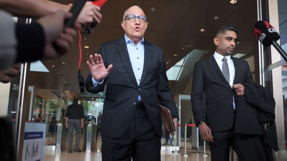 epaselect epa11639054 Singapore's former Minister of Transport S. Iswaran gestures towards media members as he leaves the Supreme Court after being sentenced to 12 months in prison, in Singapore, 03 October 2024. Iswaran has been sentenced to 12 months imprisonment after he was convicted of five charges, including four counts of accepting gifts as a public servant and one count of obstructing justice. He requested to surrender on 07 October to begin serving his sentence, which was granted by the judge.  EPA/SIMON LIM