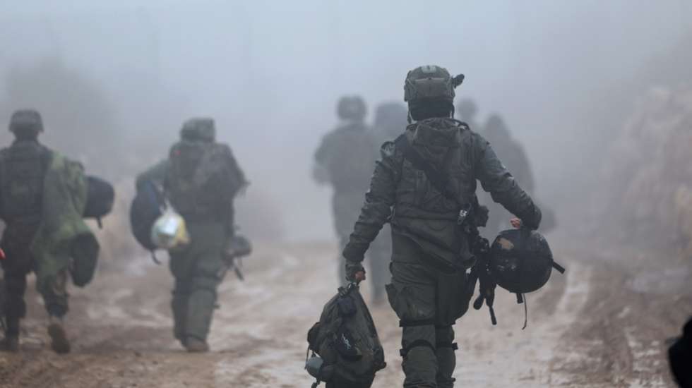 epa11789591 Israeli soldiers make their way to the Syrian side of the buffer zone on the border between Israel and Syria, near the Druze village of Majdal Shams, in the Israeli-annexed Golan Heights, 22 December 2024. Israel's military said that its troops are conducting 'defense activities' along the border with Syria in the Golan Heights, northern Golan Heights, and Mount Hermon, to prevent 'any threat' from 'terrorist elements' in the area.  EPA/ATEF SAFADI
