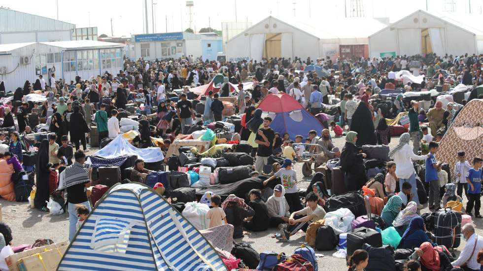 epa12200604 Afghan refugees, who have recently returned from neighboring Iran, register with Afghan and UN authorities before leaving for their hometowns, at Islam Qala border with Iran, in Herat, Afghanistan, 26 June 2025 (issued 27 June 2025). In a significant surge, over thousands of Afghan refugees have re-entered Herat province through the Islam Qala border from Iran within the past two days, contributing to a total of more than 100,000 returnees in the last week. Maulvi Ahmadullah Mottaqi, Head of Information and Culture for Herat, reported that the Refugee Affairs Commission is prepared to provide essential services such as water, food, and immediate care for the returning individuals. This mass repatriation is attributed to various factors, including recent Israeli attacks on Iranian cities, the expiration of residency permits for Afghan refugees in Iran, escalating economic hardships, and increased expulsion efforts by Iranian authorities.  EPA/STRINGER