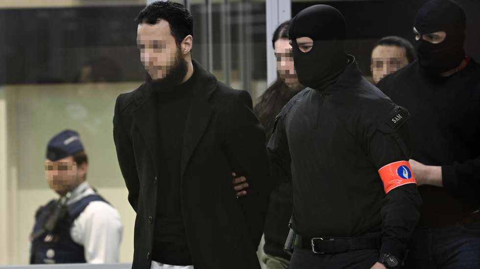 epa10556588 Defendants Salah Abdeslam, Osama Krayem and Mohamed Abrini are escorted by police as they arrive in court during the trial of the 2016 Brussels terror attacks at the Justitia building in Brussels, Belgium, 03 April 2023. Nine defendants are on trial over the March 22, 2016, bomb attacks at Brussels' Zaventem airport and Maelbeek metro station, that killed 32 people, and which were claimed by the Islamic State (IS) extremist group.  EPA/JOHN THYS / POOL  ATTENTION EDITORS: Faces pixelated at source  MAXPPP OUT