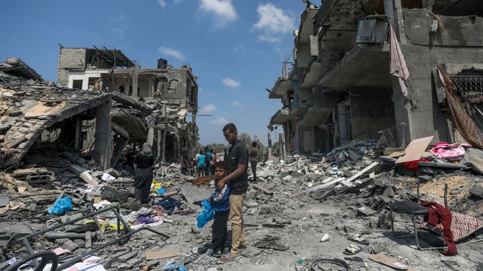 epa11280159 Palestinians inspect their destroyed houses in Al Maghazi refugee camp, central Gaza Strip, 15 April 2024, following Israeli air strikes. More than 33,700 Palestinians and over 1,450 Israelis have been killed, according to the Palestinian Health Ministry and the Israel Defense Forces (IDF), since Hamas militants launched an attack against Israel from the Gaza Strip on 07 October 2023, and the Israeli operations in Gaza and the West Bank which followed it.  EPA/MOHAMMED SABER