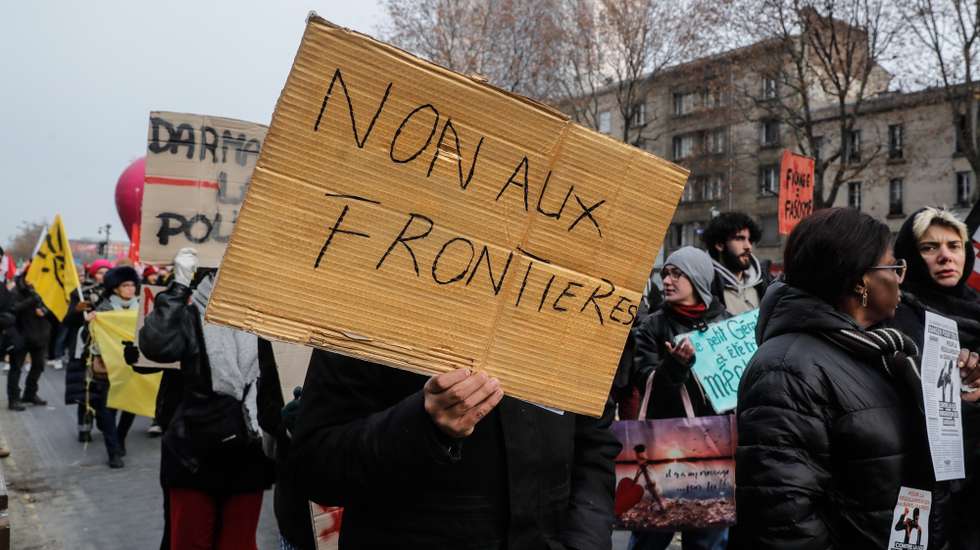 epa10371757 A placard 'No to Borders' as People demonstrate for migrant rights during the Solidarity Walk marking the International Migrants Day, in Paris, France, 18 December 2022. French national assembly is currently discussing the new migration law, which one of the main points is a residence permit, to recruit migrants for jobs, where there is a lack of manpower.  EPA/TERESA SUAREZ