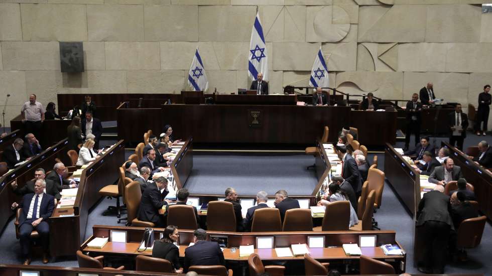 epa10766137 Israel's Knesset Speaker Amir Ohana (C) presides over a session to vote on law on justice system reform, Israel, 24 July 2023. Mass protests continue across the country as the Israeli parliament, or Knesset, is set to hold a final vote on the bill that would limit the Supreme Court's powers.  EPA/ABIR SULTAN