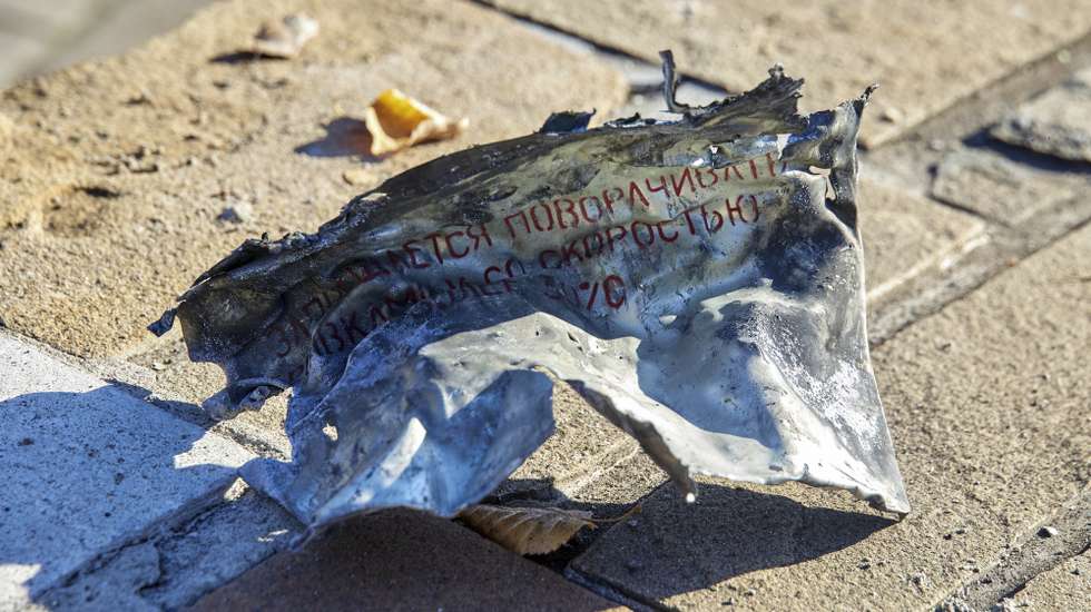 epa10230944 Debris of an S-300 missile with Russian writing is collected after being shut down over Kharkiv, Ukraine, 08 October 2022. Kharkiv and surrounding areas have been the target of heavy shelling since February 2022, when Russian troops entered Ukraine territory, starting a conflict that has provoked destruction and a humanitarian crisis.  EPA/SERGEY KOZLOV