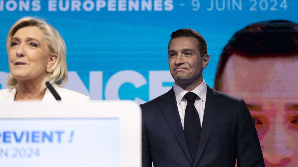epa11400774 National Rally leader Jordan Bardella (R) reacts as parliamentary party leader Marine Le Pen (L) delivers a speech at the electoral party of the French right-wing party National Rally (Rassemblement National or RN) in Paris, France, 09 June 2024, after the first results of the European elections. The list of the Rassemblement National, led by party chief Jordan Bardella, is given winner in France according to first estimations after polls.  EPA/ANDRE PAIN