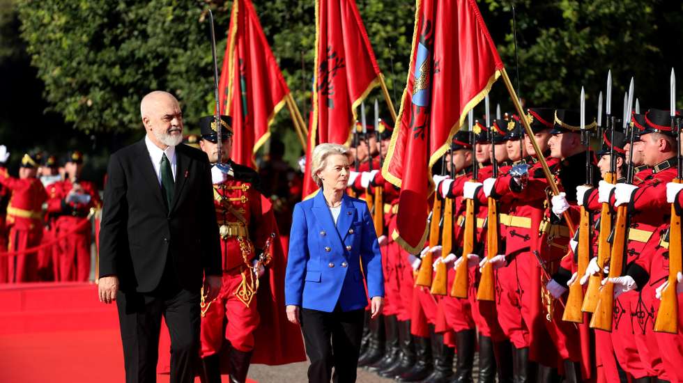 epa11677338 Albania's Prime Minister Edi Rama (L) and European Commission President Ursula von der Leyen (R) inspect the honor guard ahead of their meeting in Tirana, Albania, 23 October 2024. European Commission President Ursula von der Leyen is on an official visit to Albania.  EPA/MALTON DIBRA