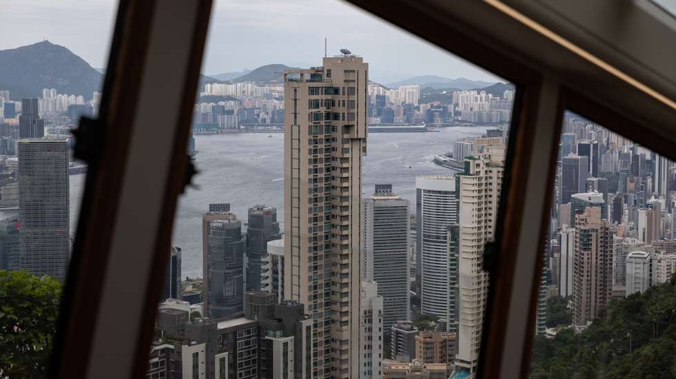 epa10135663 Residential and commercial buildings stand on Hong Kong island and the Kowloon Peninsula as seen from the 6th Generation Peak Tram during an unveiling press preview trip in Hong Kong, China, 24 August 2022. The Peak Tram cars will open to the public on 27 August 2022, after an upgrade project that included the replacement of all haulage, control and signalling systems, ropes and track trails. The new Peak Tram has been manufactured in Switzerland by Garaventa and comprises two cars with a capacity of 210 passengers.  EPA/JEROME FAVRE