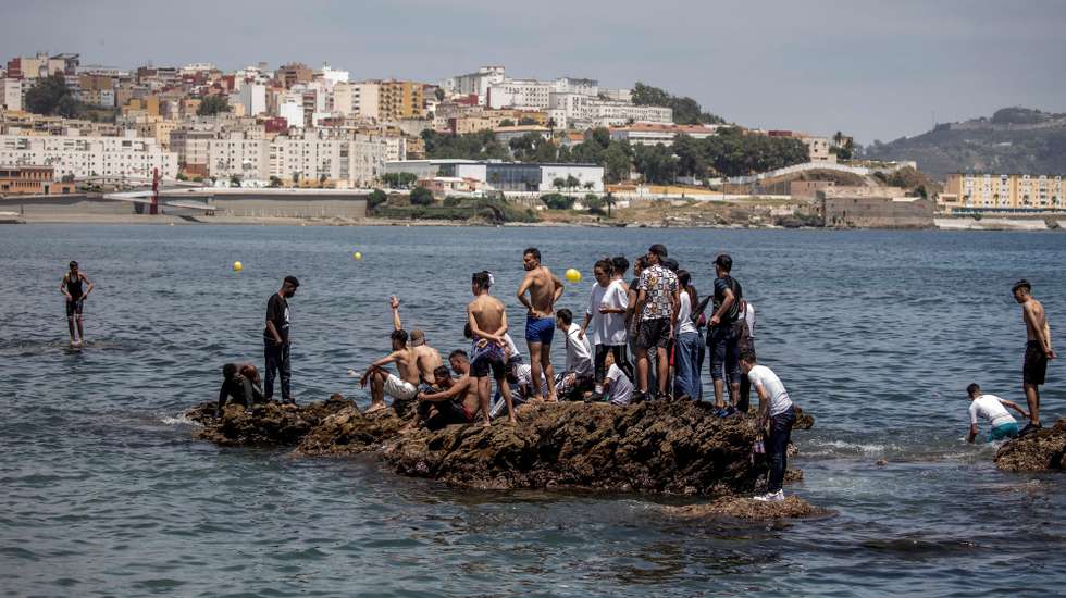 epa09209430 Migrants arrive swimming to cross the border of Tarajal in Ceuta, Spain, 18 May 2021. On the night of 17 May, a total of 5,000 Moroccan nationals entered into the Spanish city of Ceuta, loacted in the North African coast, by sea side and hundreds of migrants continue to attempt doing so. The Spanish authorities have deployed the army to patrol on the border separating Ceuta in the Spanish side from the Moroccan side, in a bid to control this latest surge of entry attempts.  EPA/BRAIS LORENZO