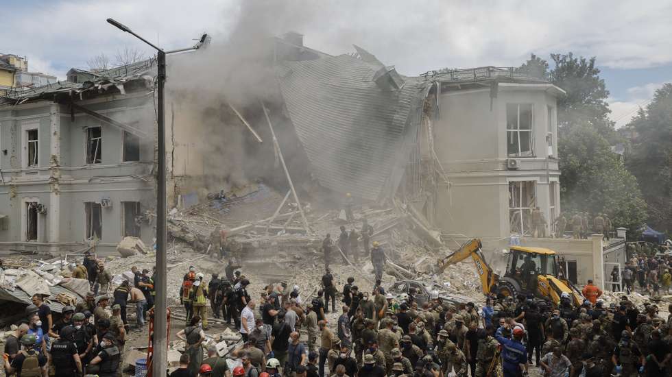 epa11466653 Rescue workers at the site of a rocket strike on the 'Okhmadyt' children's hospital in Kyiv, Ukraine, 08 July 2024 amid the undoing Russian invasion. Russia massively attacked Ukraine with missiles 08 July, striking Kyiv, Dnipro, Kryvyi Rih, Sloviansk and Kramatorsk. More than 40 missiles of different types were launched, striking residential buildings, infrastructure and the children's hospital. At least seven people were killed and 25 injured as result of shelling in Kyiv according to the State Emergency Service report.  EPA/SERGEY DOLZHENKO