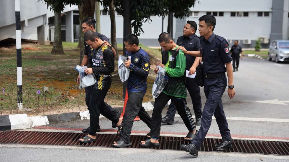 epa11613134 Royal Malaysian Police officers escort three members of Global Ikhwan Services and Business Holdings (GISBH) as they depart after facing charges at a court in Seremban, Malaysia, 19 September 2024. The three suspects, detained during recent operations involving the raid of 20 welfare homes allegedly linked to GISBH, will be charged under Sections 14(a) and 14(b) of the Sexual Offenses Against Children Act 2017 (Act 792). The raid resulted in 171 arrests for 'neglect and mistreatment' of children, according to a police statement from 11 September.  EPA/FAZRY ISMAIL