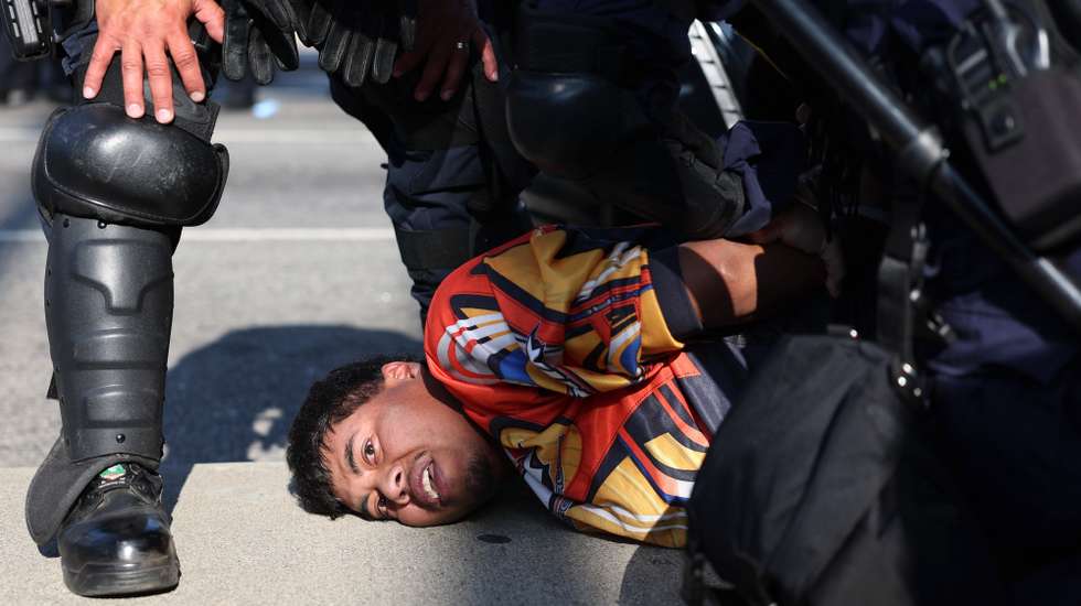 epa12169355 A protestor is arrested during protests sparked by immigration raids in Los Angeles, California, USA, 10 June 2025. Approximately 2,000 National Guard troops were deployed on 08 June in Los Angeles by US President Donald Trump, though the state of California had not requested any additional assistance, and protests have continued against the Trump administration's immigration enforcement raids over the last couple of days.  EPA/ALLISON DINNER