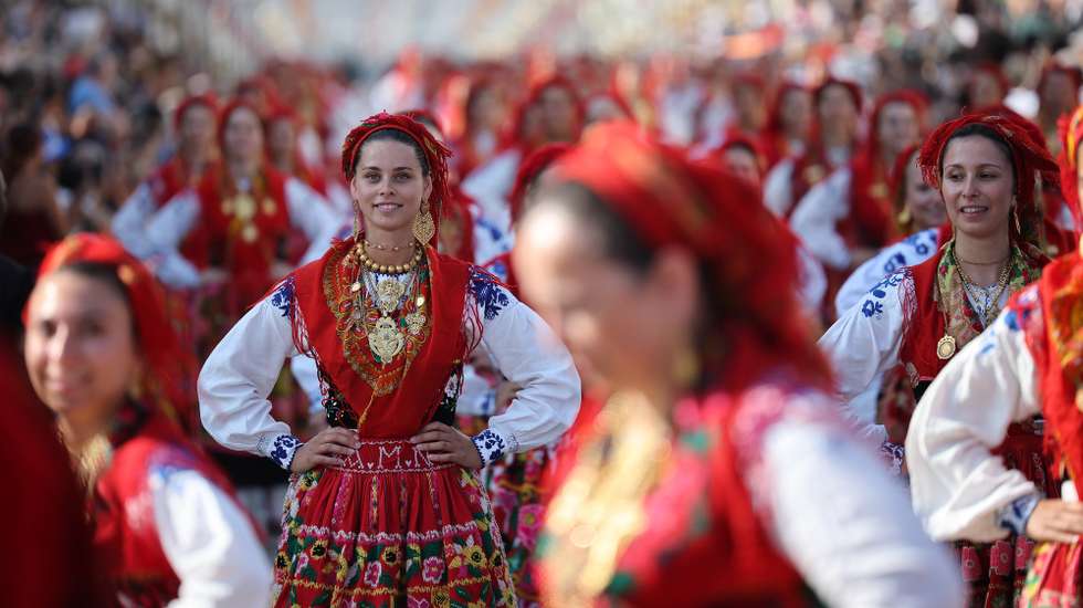 Portuguese women wearing traditional gold attached costumes takes part in the annual parade of Our Lady Of Agony (Agonia) Pilgrimage in Viana do Castelo, Portugal, 19 August 2026. The pilgrimage dates back to the 18th century and is celebrated in August. The gold adorning the costumes has an overall estimated value of several million euros. ESTELA SILVA/LUSA