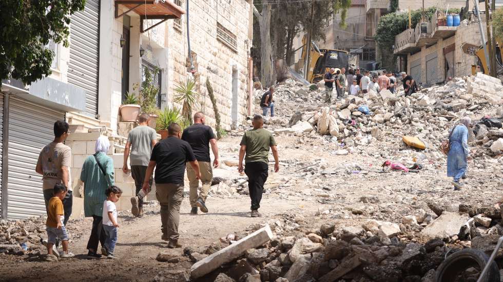 epa11589228 Palestinians inspect the damage after a ten-day Israeli military operation in Jenin, West Bank, 06 September 2024. At least 39 Palestinians, including eight children and two elderly people, have been killed and around 150 others injured since the start of Israeli military operations in the West Bank on 28 August 2024, according to the Palestinian Ministry of Health. The Israeli military stated on 06 September, that Israeli forces have conducted 'counterterrorism activity' in the area of Jenin over the past week and a half, adding that 14 'terrorists' have been killed, over 30 suspects detained and four aerial strikes were conducted in the area.  EPA/ALAA BADARNEH