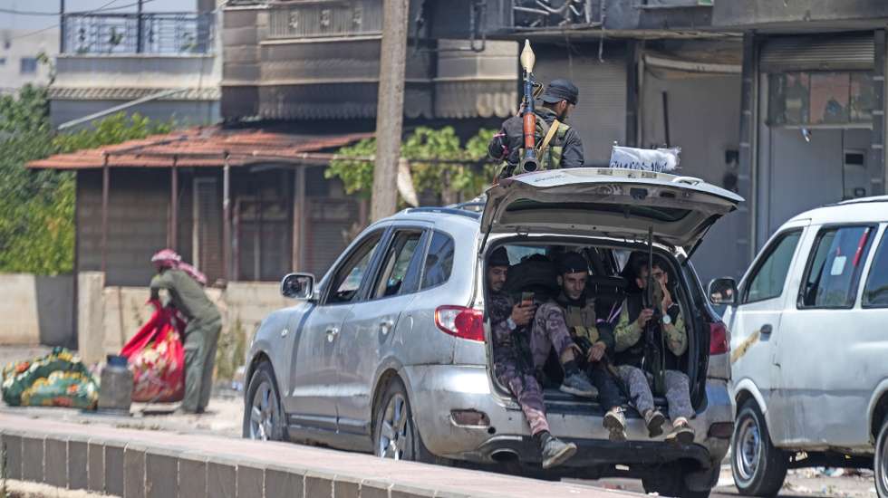 epa12245144 Fighters from Bedouin tribes roam the town of Al-Mazra'a in the Suwayda countryside, southern Syria, after the tribes launched extensive military operations against Druze factions following the killing and displacement of Arab Bedouins from the Suwayda countryside by Druze factions on 18 July 2025.  Several Bedouin tribes declared a general mobilization to fight against Druze factions after local Druze factions displaced Bedouin families and killed dozens of them.  EPA/AHMAD FALLAHA