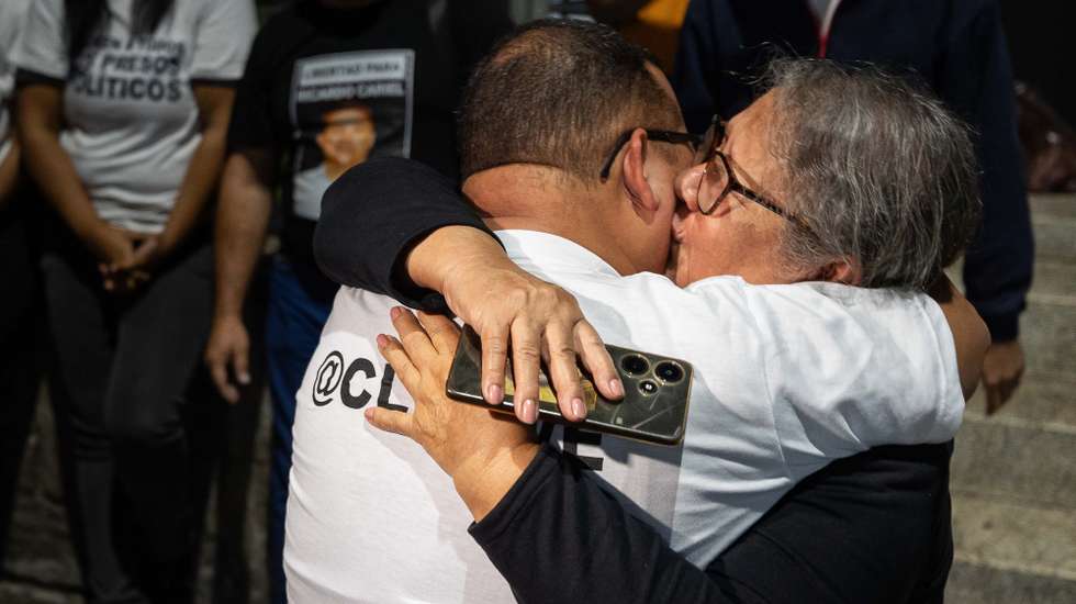 epa12770616 Lewis Jose Mendoza (L), the political leader of Vente Venezuela, embraces his mother upon release from the Bolivarian National Police headquarters in La Yaguara, Caracas, Venezuela, 22 February 2026.  EPA/Ronald Pena R