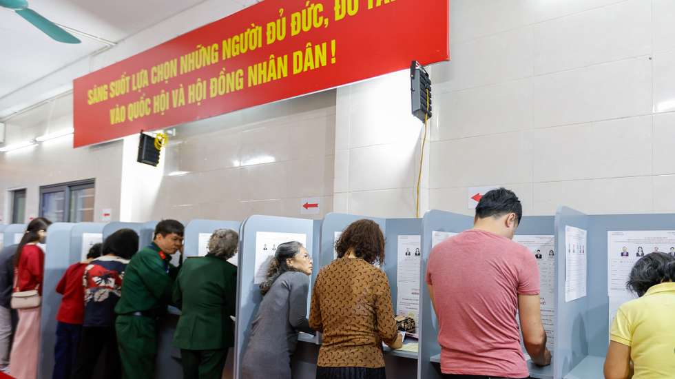 epa12820468 People fill out ballot papers at a polling station in Hanoi, Vietnam 15 March 2026. Vietnam holds general elections for the 16th National Assembly and People's Councils at all levels for the 2026–2031 term on 15 March.  EPA/LUONG THAI LINH
