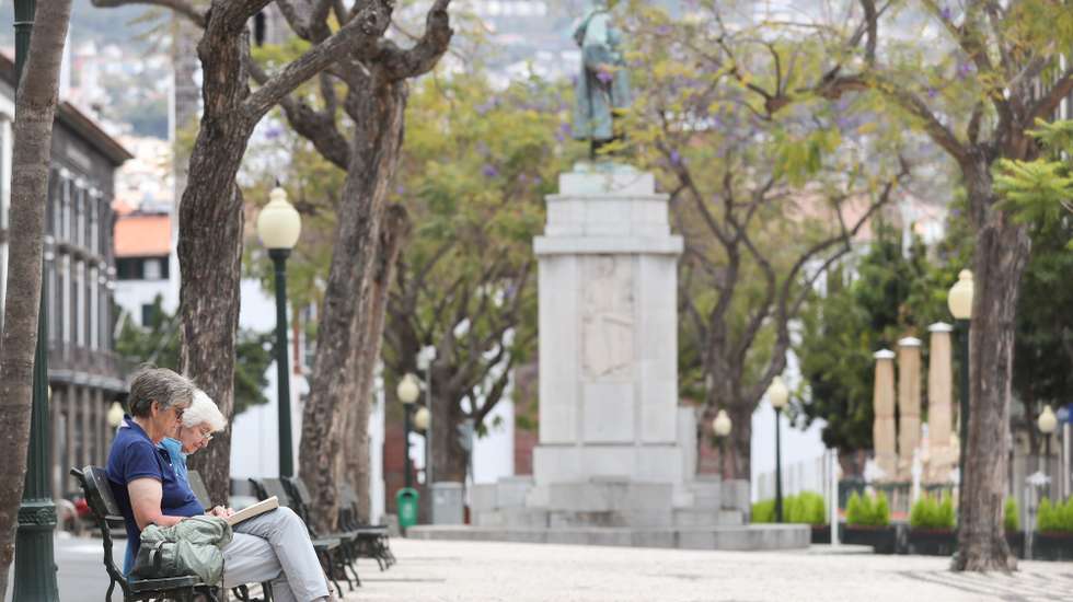 epa08312089 Two tourists read sit on a bench in a garden without people in the centre of Funchal due to the epidemic of covid-19, Madeira Island, Portugal, 21 March 2020. In Portugal, there are 12 deaths and 1,280 confirmed infections. Portugal is in a state of emergency from 00:00 on March 19th until 23:59 on 02 April. Countries around the world are taking increased measures to stem the widespread of the SARS-CoV-2 coronavirus which causes the Covid-19 disease.  EPA/HOMEM DE GOUVEIA