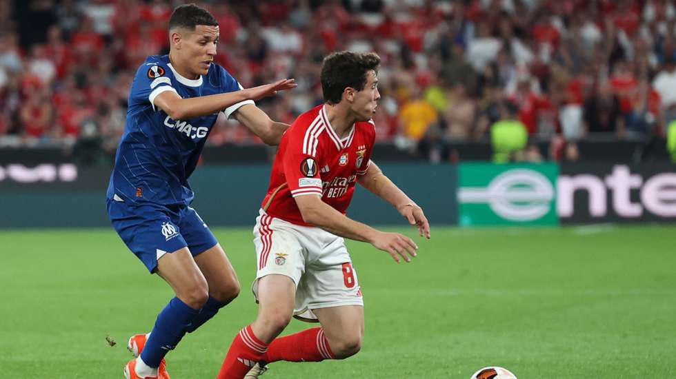 Benfica player Joao Neves (R) in action against Olympique de Marseille Amine Harit during the UEFA Europe League quarter-final first leg soccer match between Benfica and Olympique de Marseille held at Luz Stadium, in Lisbon, Portugal, 11 April 2024. MANUEL DE ALMEIDA/LUSA