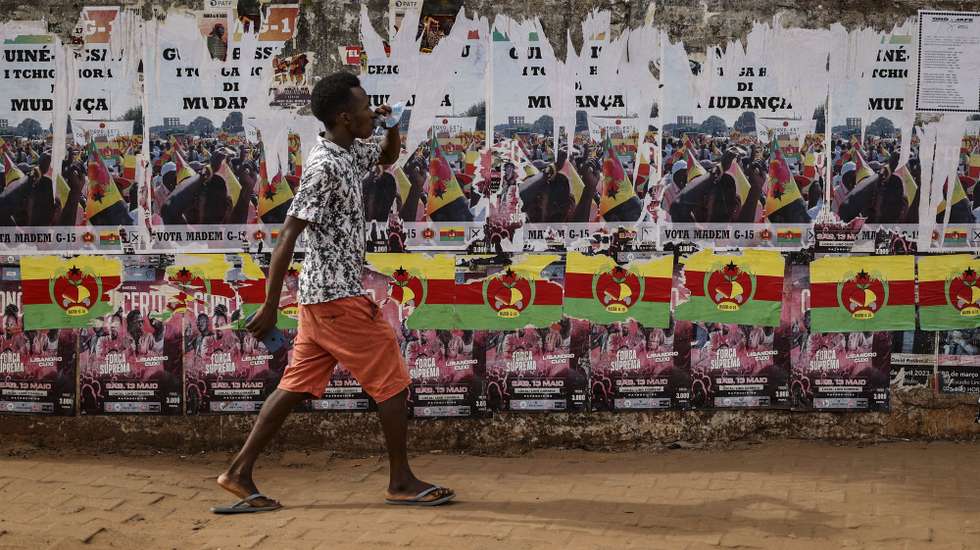 A man walks near a wall with posters of several candidates for the Guinea-Bissau’s legislative elections, in Bissau, 28 May 2023. The polls to choose 102 deputies among 20 parties and two coalitions were scheduled 4th June 2023 following the dissolution of the National People’s Assembly (NPA) by President Umaro Sissoco Embaló in May 2022. ANDRE KOSTERS / LUSA