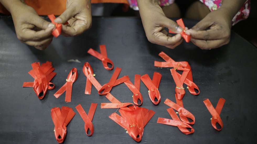 epa08037313 Princy Mangaika, Executive Director of Positive Women's Network (PWN), herself an HIV infected patient and another female make AIDS awareness ribbons at her residence in Colombo, Sri Lanka 01 December 2019. Mangalika, a mother of two acknowledges that she contracted the Human Immunodeficiency Virus (HIV) in 1999 from her spouse who had worked overseas and identified as positive in 2000, and says that those in her village had set their home on fire when they became aware of their illness. Without giving up hope, she has continued to assist in awareness-raising and also runs a care center for several AIDS patients. Currently, her organization WomenÕs Network (PWN) has 586 members including 44 children. Several events were held in Colombo to coincide with World AIDS Day on 1st December. The estimated number of people infected with HIV in Sri Lanka is around 3500 to - 4200 by 2018, but only around two-thirds of them know that they have HIV, according to the National STD/AIDS Control Programme (NSACP) of the Ministry of Health, Sri Lanka. The island nation aims to completely eradicate Human Immunodeficiency Virus (HIV) and the Acquired Immunodeficiency Syndrome (AIDS) by the year 2030.  EPA/Chamila Karunarathne
