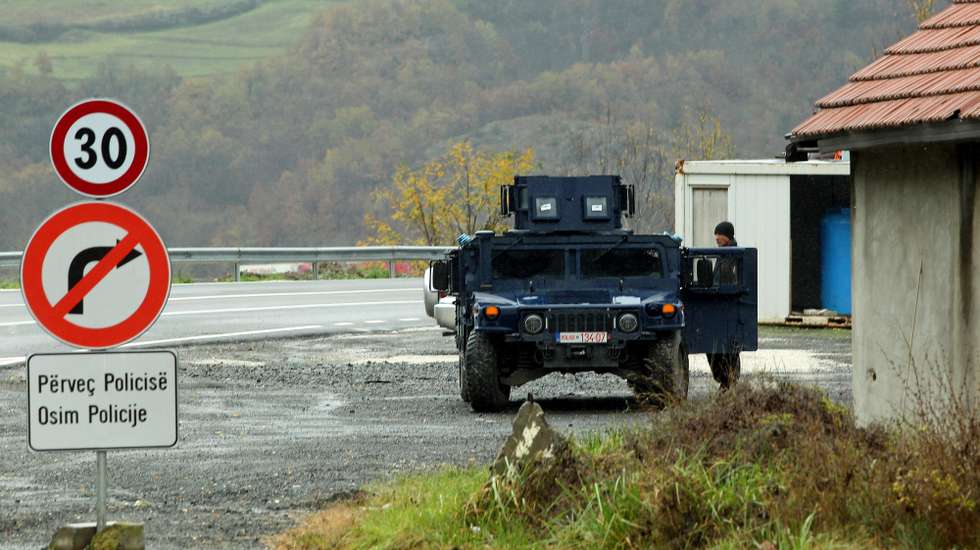 epa10290165 Kosovo special police officers stand guard near Northern Mitrovica, Kosovo, 06 November 2022. Kosovo Serbs protested after a dispute over license plates and personal documents that triggered a Serb walkout from their jobs in institutions of Republic of Kosovo.  EPA/DJORDJE SAVIC