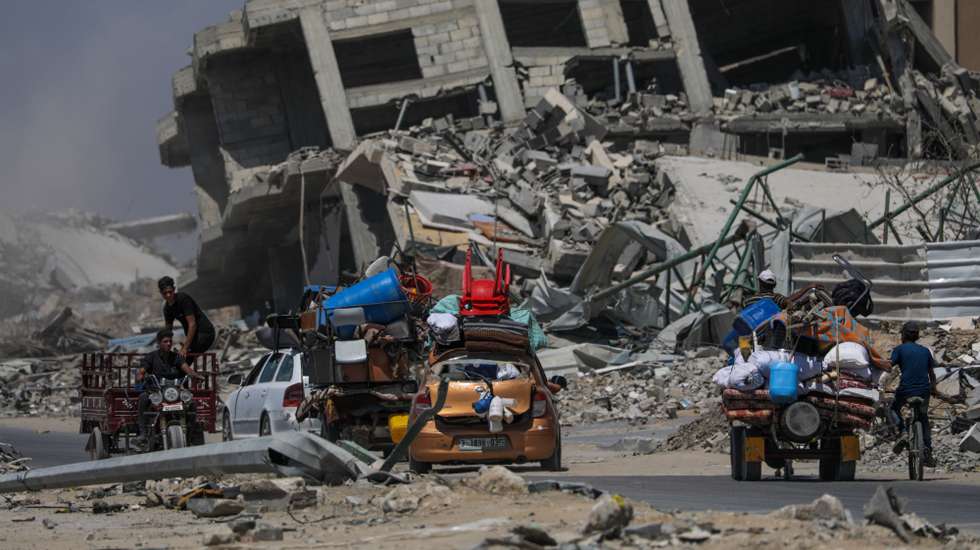 epa11453129 Internally displaced Palestinians leave with their belongings following an evacuation order issued by the Israeli army, in Khan Younis, southern Gaza Strip, 02 July 2024. More than 37,000 Palestinians and over 1,455 Israelis have been killed, according to the Palestinian Health Ministry and the IDF, since Hamas militants launched an attack against Israel from the Gaza Strip on 07 October 2023, and the Israeli operations in Gaza and the West Bank which followed it.  EPA/MOHAMMED SABER