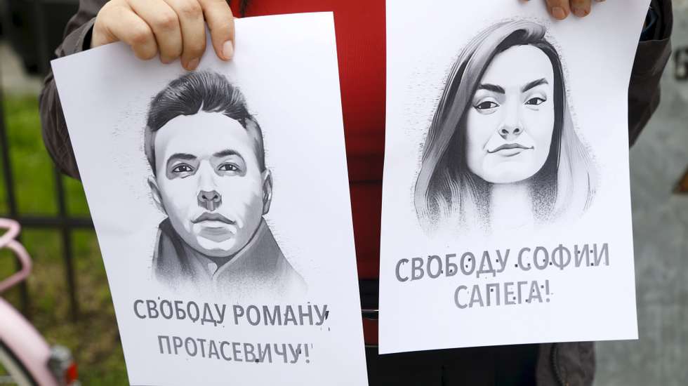 epa09226579 A woman holds a portrait of opposition journalist Roman Protasevich and his girlfriend Sofia Sapega during a protest of solidarity with Roman Protasevic at the Belarusian embassy in Riga, Latvia, 25 May 2021. Belarus&#039; opposition journalist Roman Protasevich was detained by Belarusian Police on 23 May on a Ryanair flight from Athens to Vilnius, that was forced to land in Minsk.  EPA/TOMS KALNINS