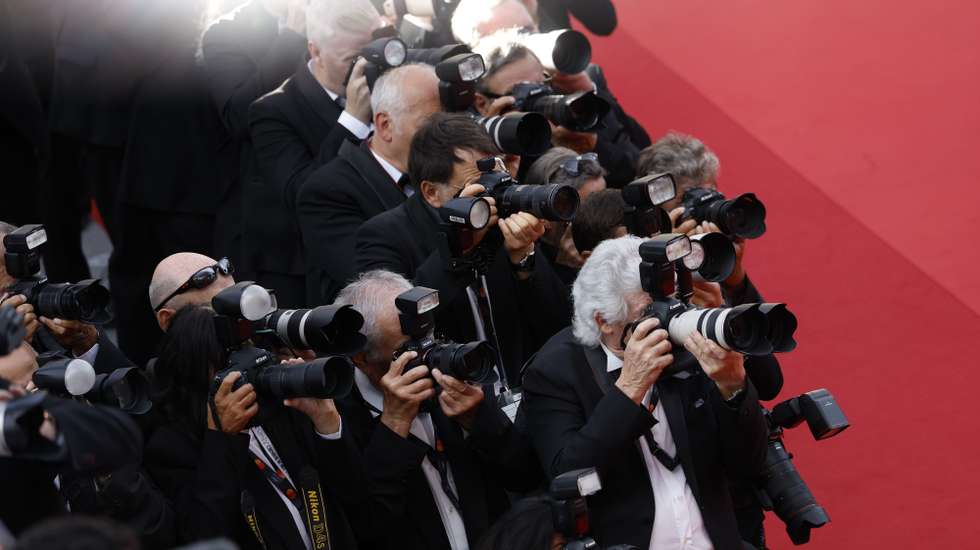 epa11367068 Photographers in action during the premiere of 'La Plus Precieuse Des Marchandises (The Most Precious Of Cargoes)' during the 77th annual Cannes Film Festival, in Cannes, France, 24 May 2024. The movie is presented in competition at the film festival which runs from 14 to 25 May 2024.  EPA/SEBASTIEN NOGIER