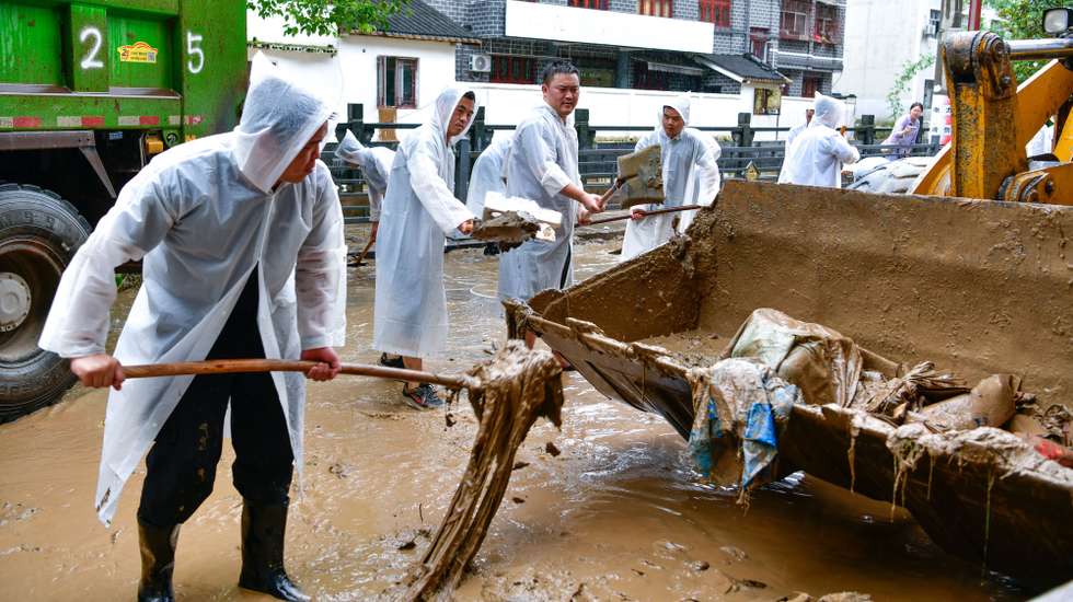 epaselect epa11447753 Police officers clean the street after flood in Zhenyuan County, southwest China's Guizhou Province, 30 June 2024. Parts of Zhenyuan County in Guizhou was hit by flood triggered by heavy rainfall from 28 to 29 June.  EPA/XINHUA / YANG WENBIN CHINA OUT / UK AND IRELAND OUT  /       MANDATORY CREDIT  EDITORIAL USE ONLY  EDITORIAL USE ONLY