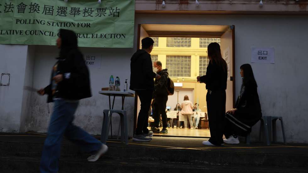 epa12576546 Citizens leaves a polling station in Tai Po during the Legislative Council General Election in Hong Kong, China, 07 December 2025. Hong Kong's 'patriots-only' Legislative Council election is held as the city mourns the deadly Wang Fuk Court fire in Tai Po, with public calls for accountability amid lingering questions about the tragedy.  EPA/MAY JAMES