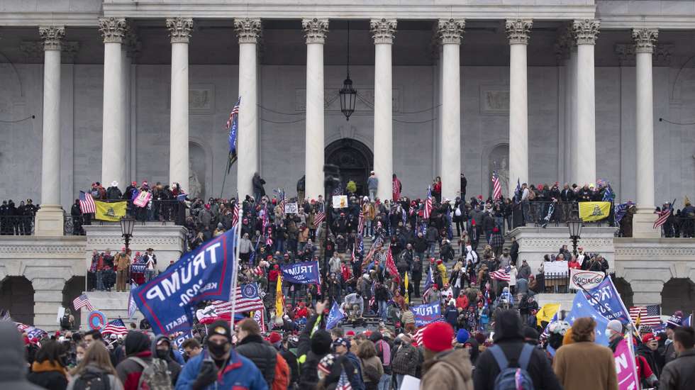 epa08923521 Pro-Trump protesters storm the grounds of the East Front of the US Capitol, in Washington, DC, USA, 06 January 2021. Right-wing conservative groups are protesting against Congress counting the electoral college votes. Dozens of state and federal judges have shot down challenges to the 2020 presidential election, finding the accusations of fraud to be without merit. Protesters stormed the US Capitol which held the Electoral College vote certification for President-elect Joe Biden.  EPA/MICHAEL REYNOLDS