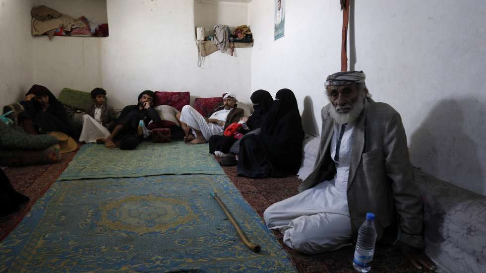 epa08495615 Yemeni displaced Mohammed Ahmed, 77, (R) and his relatives sit in a rental house in Sanaa, Yemen, 18 June 2020 (issued 19 June 2020). He says 'I have been displaced from the city of Haradh, northwestern Yemen, since 2016 due to the war that destroyed homes and roads. We displaced to Sanaa, leaving our properties there. We had no choice but to do so. We have no income except what we earn from collecting and selling plastic items. We receive a food ration from the World Food Programme once in every two months. It is not enough for a family of eight'. World Refugee Day is marked annually on 20 June. According to the UNHCR, more and more refugees today live in urban settings outside refugee camps. Some crises have lasted so long that the tent camps became built-up urban areas. While some refugees depend on international help through NGOs, others start a new life, changing everything from occupation, to social status, to adapt to their new realities.  EPA/YAHYA ARHAB  ATTENTION: This Image is part of a PHOTO SET