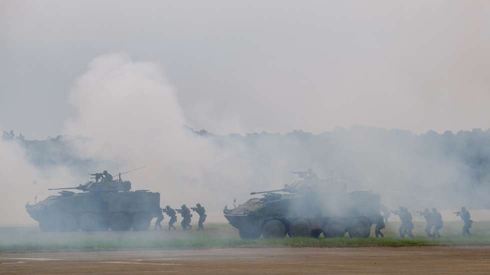 epa10873505 Taiwanese soldiers aboard CM32 battle tanks maneuver during an anti-invasion drill inside a military base in Hsinchu county, Taiwan, 21 September 2023. On 18 September, the Taiwanese military detected nine warships and 103 military aircraft from China near Taiwan. Taiwan's Ministry of National Defense has demanded that China cease its 'unilateral military harassment'.  EPA/RITCHIE B. TONGO