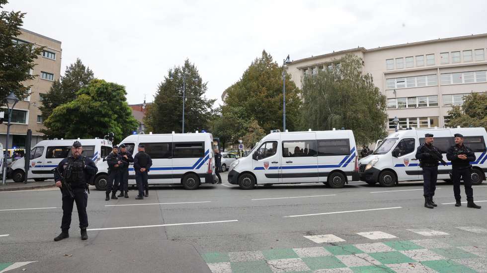 epa10916957 Police officers guard the high school in Arras, northeastern France, 13 October 2023, after a teacher was killed and two other people severely wounded in a knife attack, police said. The suspect has been detained by police, Interior Minister Gerald Darmanin said. French President Macron is expected to visit the site.  EPA/Teresa Suarez