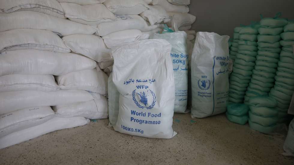 epa08963051 Free food rations are provided by the World Food Programme (WFP) at an aid distribution center in Sana'a, Yemen, 24 January 2021. According to reports, 22 aid agencies working in Yemen have called for the US administration of President Biden to revoke the designation of the Houthis movement as a foreign terrorist organization, warning that any disruption to lifesaving aid operations and essential commercial imports will put millions of lives at risk and could chill peace efforts.  EPA/YAHYA ARHAB