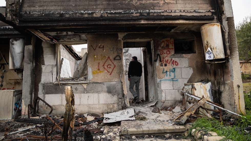 epaselect epa10989458 A man enters a damaged home during a press visit at Kfar Aza Kibbutz, southern Israel, 22 November 2023. The kibbutz, located near the Gaza border, was the scene of an Hamas attack on 07 October which resulted in the deaths of dozens of Israelis. More than 12,700 Palestinians and at least 1,200 Israelis have been killed, according to the Israel Defense Forces (IDF) and the Palestinian health authority, since Hamas militants launched an attack against Israel from the Gaza Strip on 07 October, and the Israeli operations in Gaza and the West Bank which followed it.  EPA/CHRISTOPHE PETIT TESSON