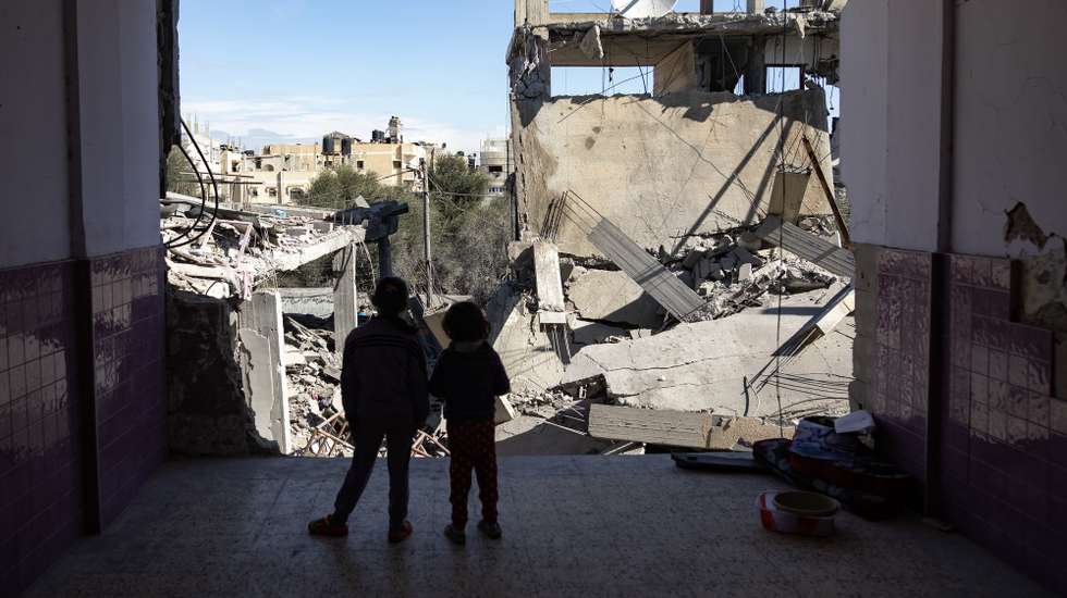 epaselect epa11125803 Two Palestinian children stand near the rubble of a destroyed residential building in Rafah refugee camp, southern Gaza Strip, 04 February 2024, following Israeli air strikes. More than 27,000 Palestinians and over 1,300 Israelis have been killed, according to the Palestinian Health Ministry and the Israel Defense Forces (IDF), since Hamas militants launched an attack against Israel from the Gaza Strip on 07 October 2023, and the Israeli operations in Gaza and the West Bank which followed it.  EPA/HAITHAM IMAD