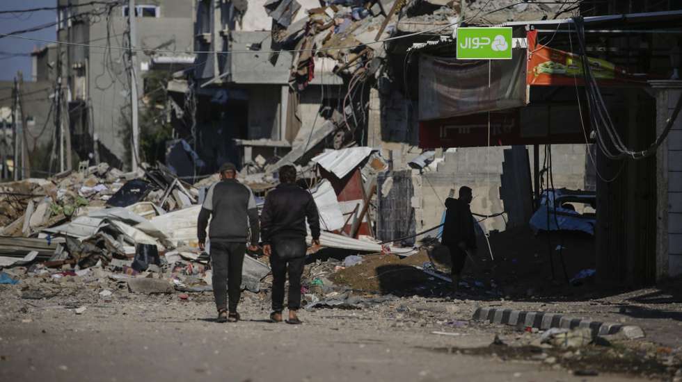 epa11083159 Palestinains walk in a destroyed street of Al Nusairat refugee camp in the southern Gaza Strip, 16 January 2024.  More than 24,000 Palestinians and at least 1,300 Israelis have been killed, according to the Palestinian Health Ministry and the Israel Defense Forces (IDF), since Hamas militants launched an attack against Israel from the Gaza Strip on 07 October, and the Israeli operations in Gaza and the West Bank which followed it. Since 07 October, up to 1.9 million people, or more than 85 percent of the population, have been displaced throughout the Gaza Strip, some more than once, according to the United Nations Relief and Works Agency for Palestine Refugees in the Near East (UNRWA), which added that most civilians in Gaza are in 'desperate need of humanitarian assistance and protection.  EPA/MOHAMMED SABER
