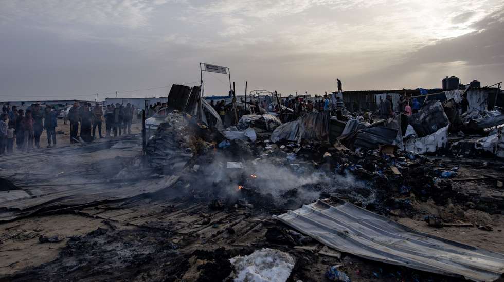 epa11372900 Palestinians inspect the damage after an Israeli army raid on a camp at an area designated for displaced people in Rafah, southern Gaza Strip, 27 May 2024. At least 40 people were killed after Israeli airstrikes hit an area in Rafah designated for the displaced, the Palestinian Civil Defense said. More than 35,000 Palestinians and over 1,400 Israelis have been killed, according to the Palestinian Health Ministry and the Israel Defense Forces (IDF), since Hamas militants launched an attack against Israel from the Gaza Strip on 07 October 2023, and the Israeli operations in Gaza and the West Bank which followed it.  EPA/HAITHAM IMAD