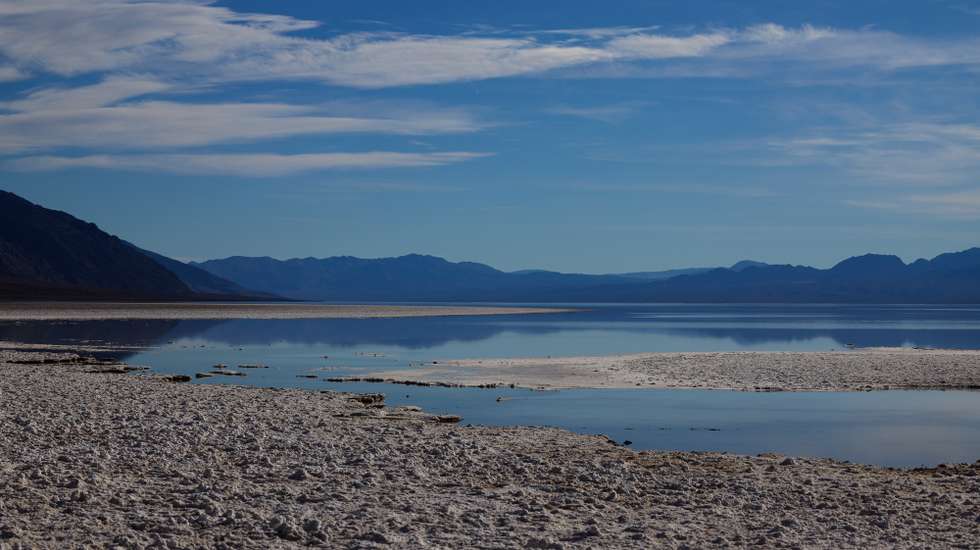 epa11107264 Months after an inundation of rain, Lake Manly is still present at Badwater Basin in Death Valley, California, USA, 26 January 2024. Lake Manly was an ancient lake that was once filled with water up to 700 feet deep during the Ice Ages, but had since dried up. The lake is located in Death Valley, which is considered the driest place in North America.  EPA/ALLISON DINNER