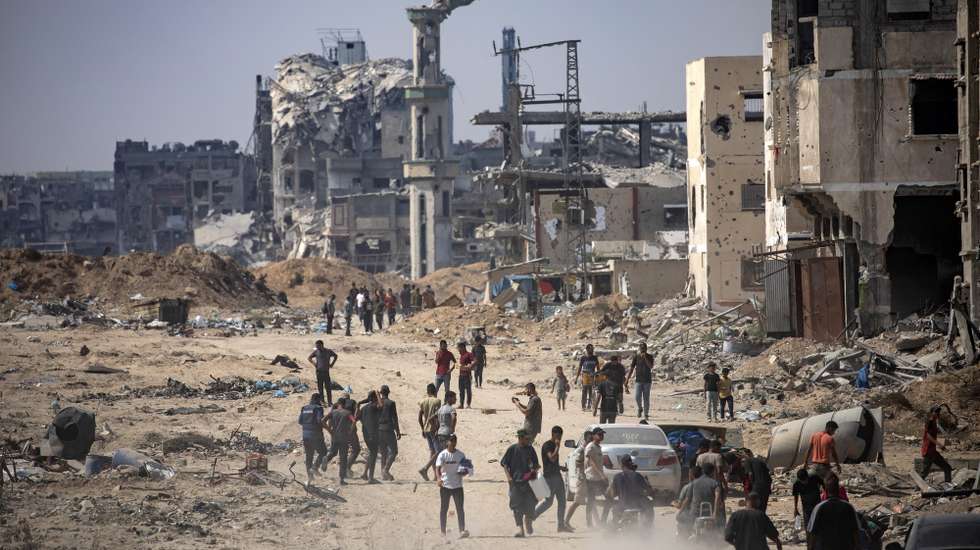 epa11573037 Internally displaced Palestinians move along a damaged street as they inspect the area after a ground military operation by Israeli forces, in Khan Younis camp, southern Gaza Strip, 30 August 2024. According to the Israel Defense Forces (IDF), 'troops have completed their divisional operation in Khan Younis and Deir al-Balah area'. More than 40,000 Palestinians and over 1,400 Israelis have been killed, according to the Palestinian Health Ministry and the Israel Defense Forces (IDF), since Hamas militants launched an attack against Israel from the Gaza Strip on 07 October 2023, and the Israeli operations in Gaza and the West Bank which followed it.  EPA/HAITHAM IMAD