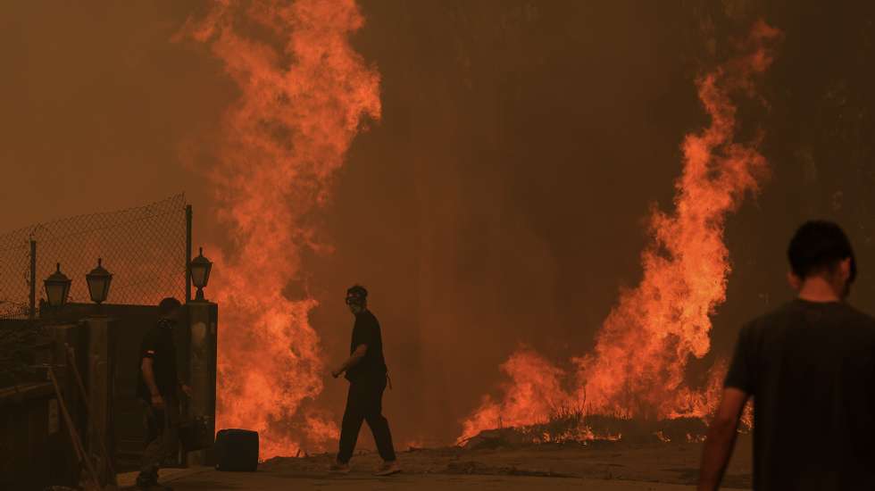 Residentes protegem as suas habitações do incêndio em Covelo, Gondomar, 17 de setembro de 2024. Desde domingo, as chamas chegaram aos distritos do Porto, em Gondomar, de Braga, em Cabeceiras de Basto, de Viseu, em Penalva do Castelo e Nelas (com seis feridos), e de Castelo Branco, em Louriçal do Campo. Mas foi o distrito de Aveiro, com 10 mil hectares já ardidos, o centro dos maiores focos de incêndio, em Oliveira de Azeméis, Sever do Vouga, Albergaria-a-Velha e Águeda. JOSÉ COELHO/LUSA